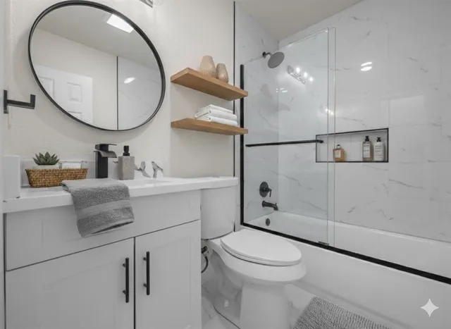 a bathroom with a sink a toilet and a mirror
