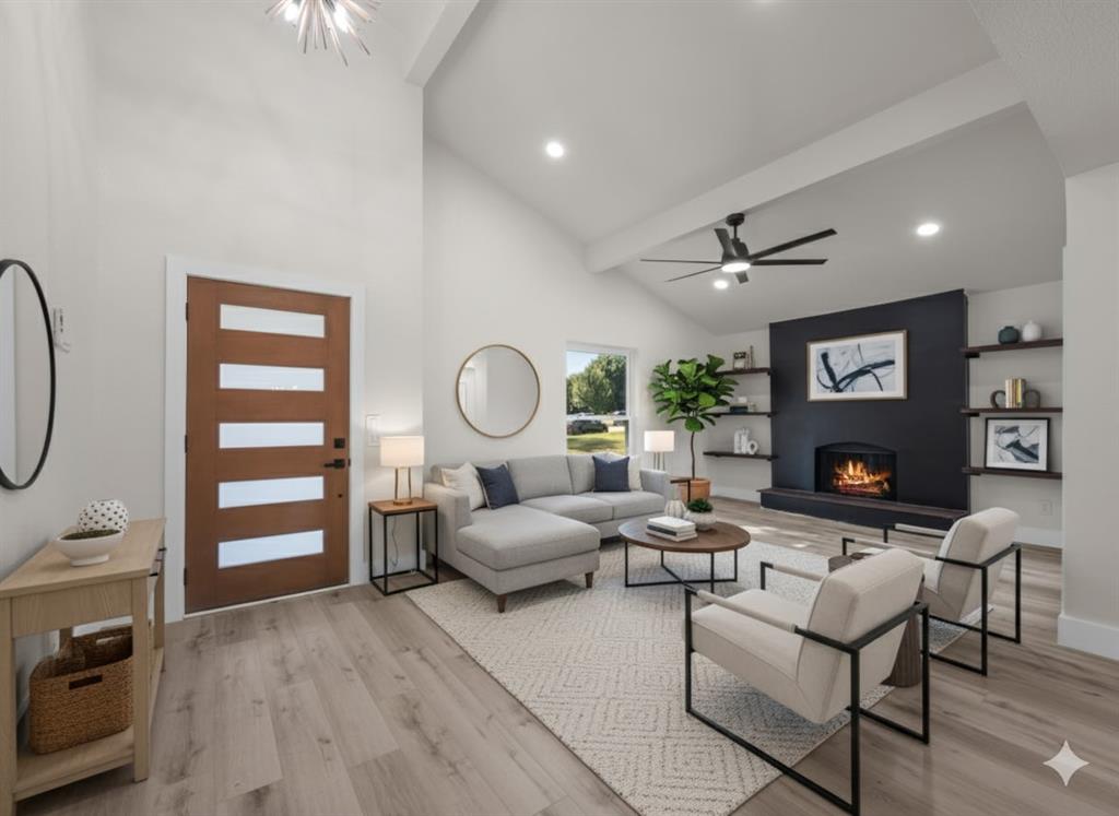 2127 Wheaton Drive Richardson, TX 75081 - Photo 8 of 33 a living room with furniture a rug and a fireplace