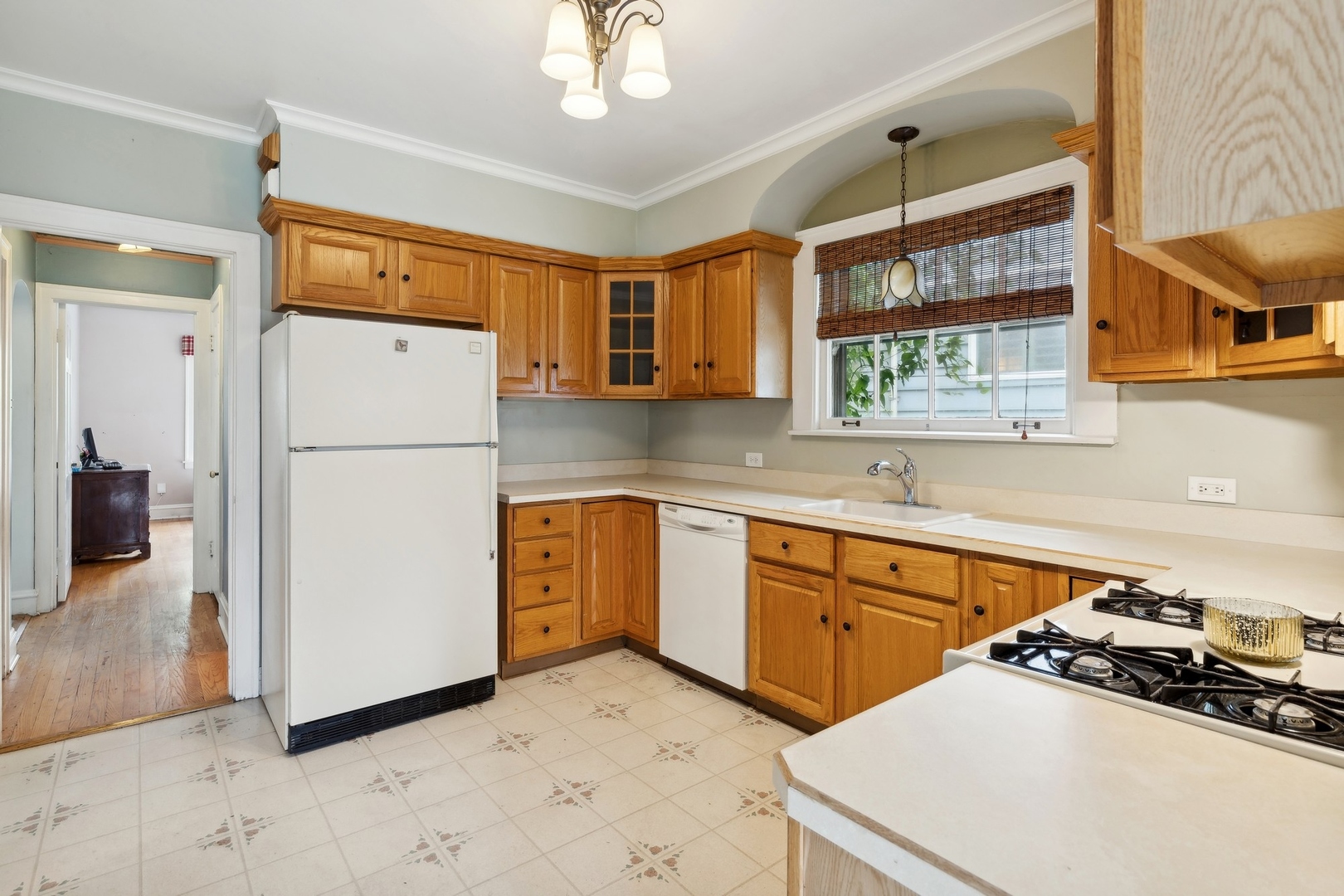 134 Wisner Street Park Ridge, IL 60068 - Photo 5 of 24 a kitchen with a refrigerator a stove a sink dishwasher a oven with white cabinets and wooden floor