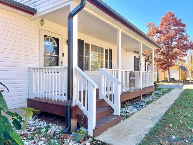a view of a house with wooden fence and porch