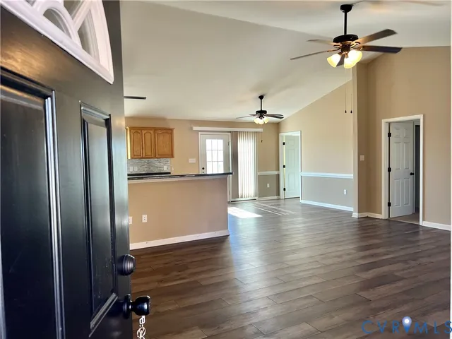 a view of a kitchen with wooden floor and a ceiling fan