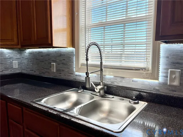 a kitchen with a sink and a window