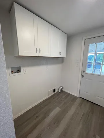 a view of storage and utility room with wooden floor