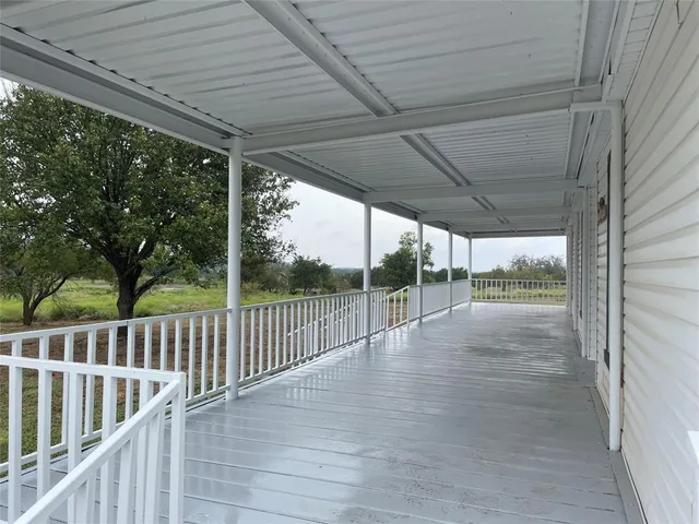 a view of balcony with wooden floor