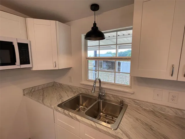 a kitchen with a sink and cabinets