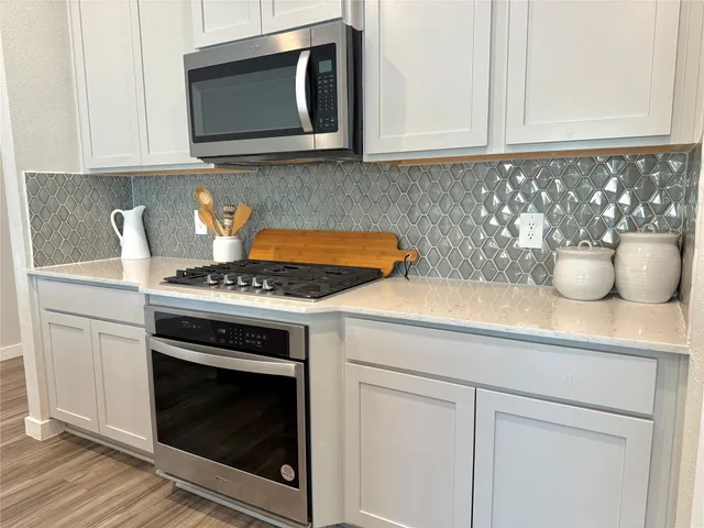 a kitchen with a stove and a microwave