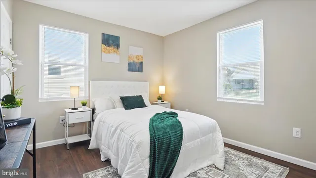 a bedroom with a bed a mirror and a potted plant