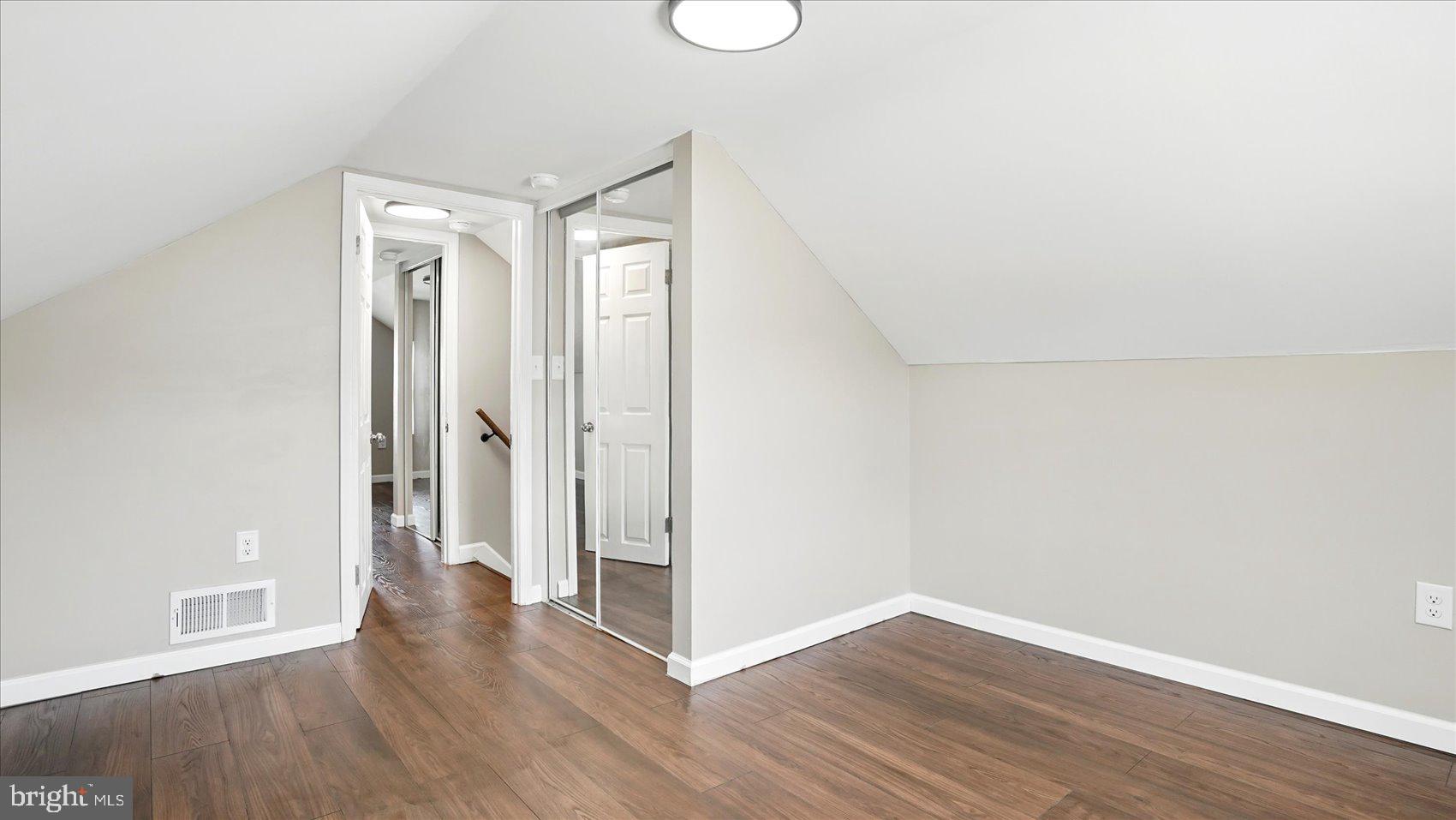 5427 Gradin Avenue Gwynn Oak, MD 21207 - Photo 12 of 24 an empty room with wooden floor and windows