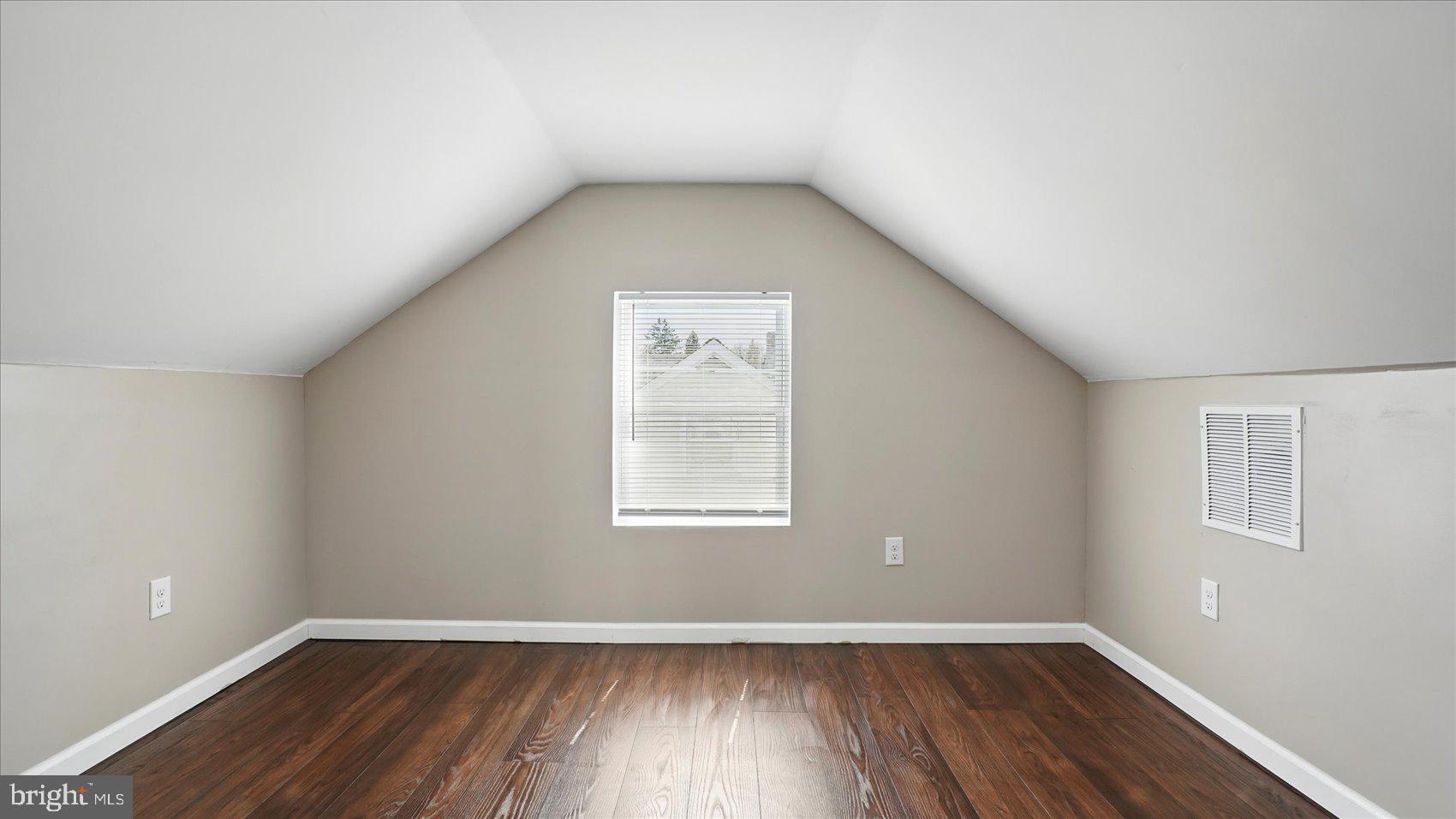 5427 Gradin Avenue Gwynn Oak, MD 21207 - Photo 13 of 24 an empty room with wooden floor and windows