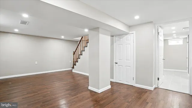 a view of a room with wooden floor