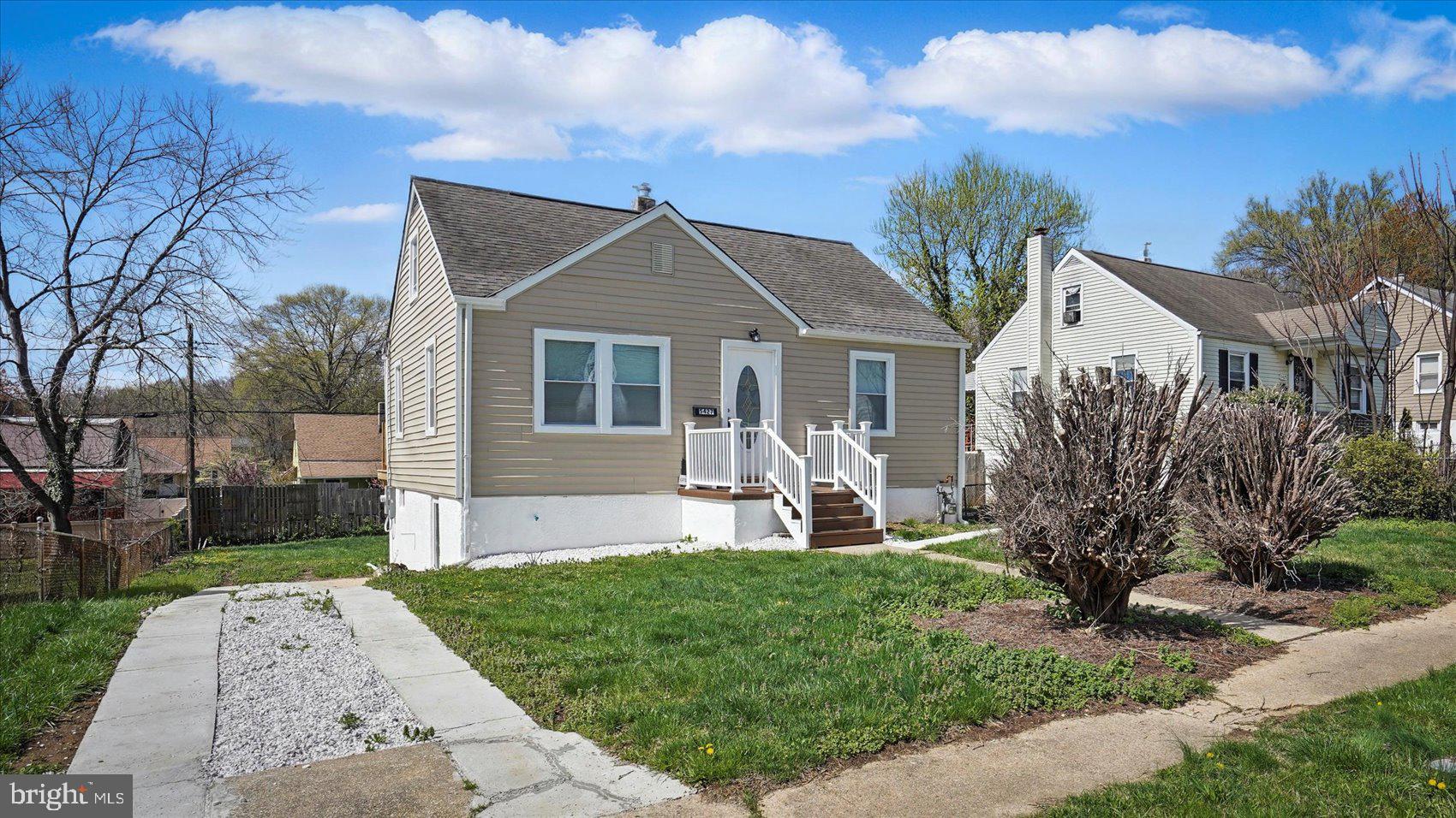 5427 Gradin Avenue Gwynn Oak, MD 21207 - Photo 19 of 24 a front view of house with yard and green space