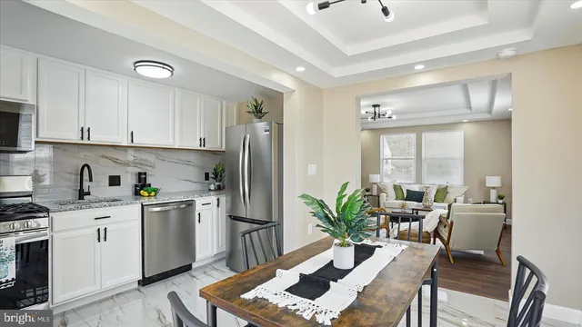 a kitchen with a table chairs a refrigerator and a stove