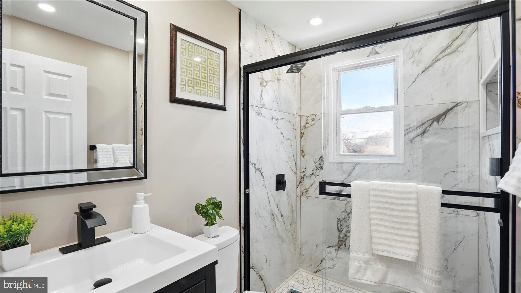 5427 Gradin Avenue Gwynn Oak, MD 21207 - Photo 7 of 24 a bathroom with a sink and a mirror