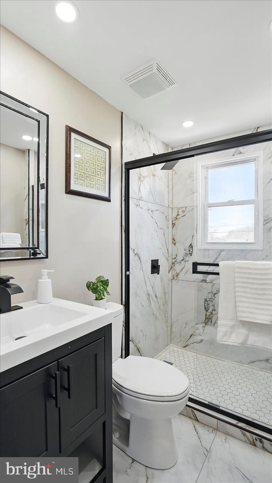 5427 Gradin Avenue Gwynn Oak, MD 21207 - Photo 8 of 24 a bathroom with a sink a toilet and shower