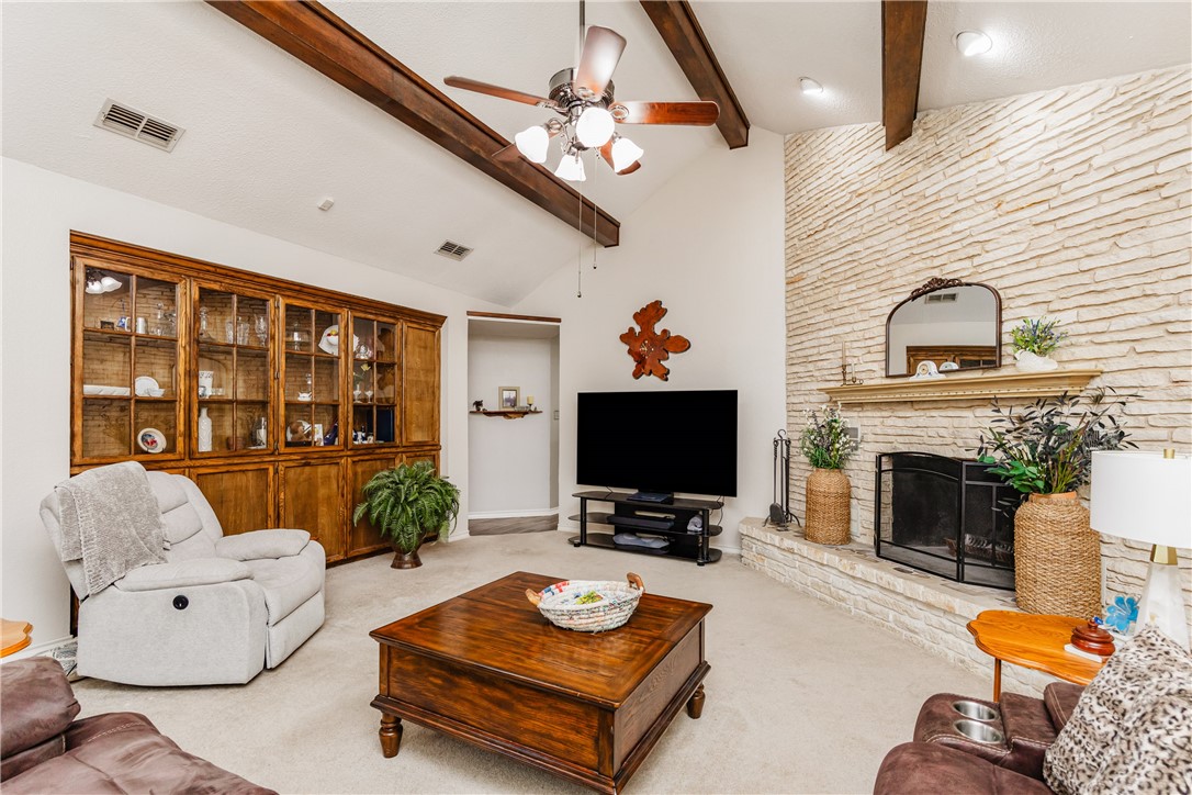 345 Trail Ridge Drive Sandia, TX 78383 - Photo 25 of 40 a living room with furniture a fireplace and a flat screen tv