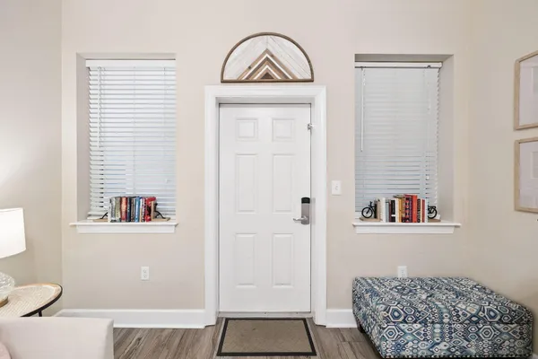 a view of a hallway with a door and a mirror