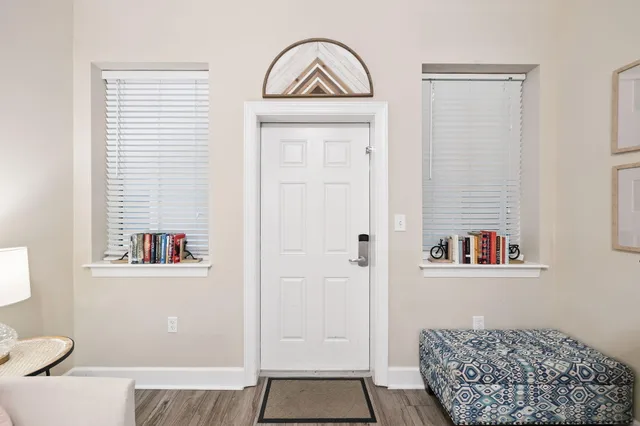 a view of a hallway with a door and a mirror