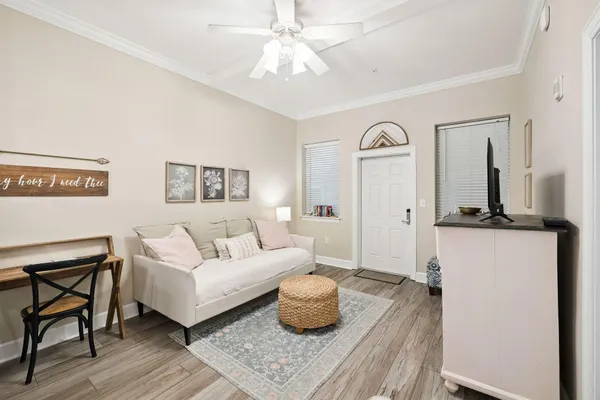 a living room with furniture and a wooden floor