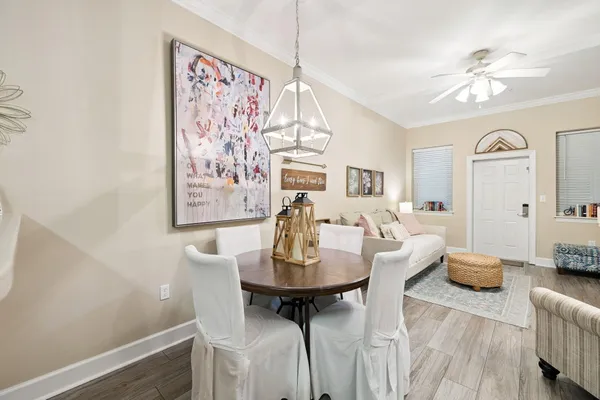 a view of a dining room with furniture and wooden floor