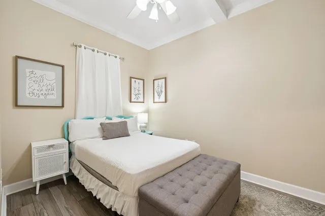 a bedroom with a bed and a chandelier