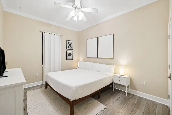a bedroom with a bed and a chandelier