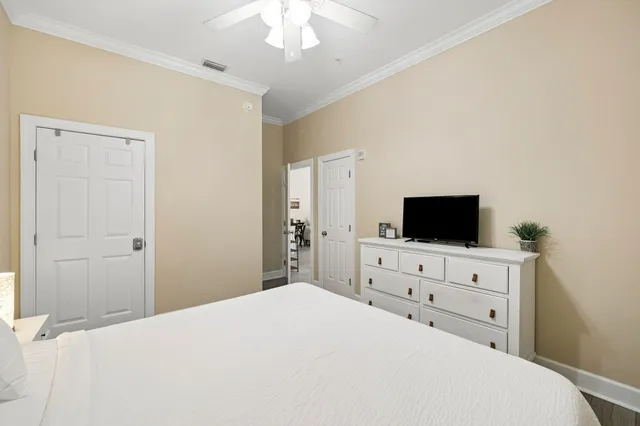 a bedroom with a bed and a flat screen tv