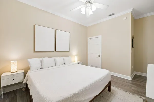 a bedroom with a large bed and a chandelier