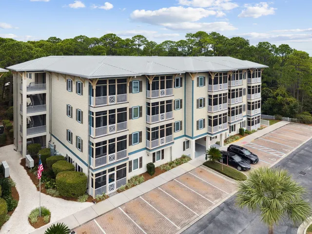 a view of a building with a garden and pathway