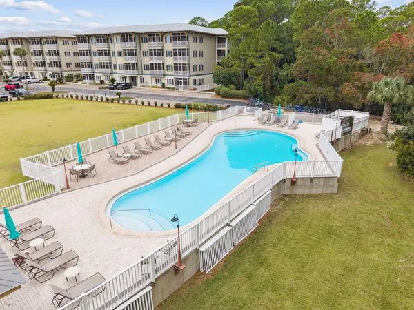a view of a swimming pool with outdoor seating