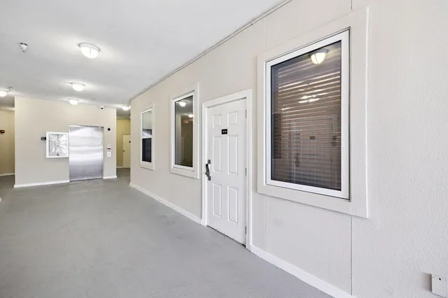 a view of a hallway with a bathroom
