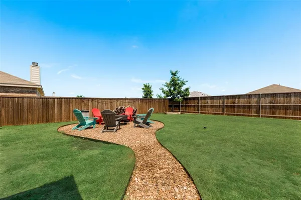 a view of a backyard with sitting area