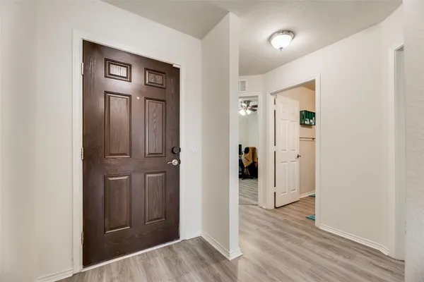 a view of a hallway with wooden floor