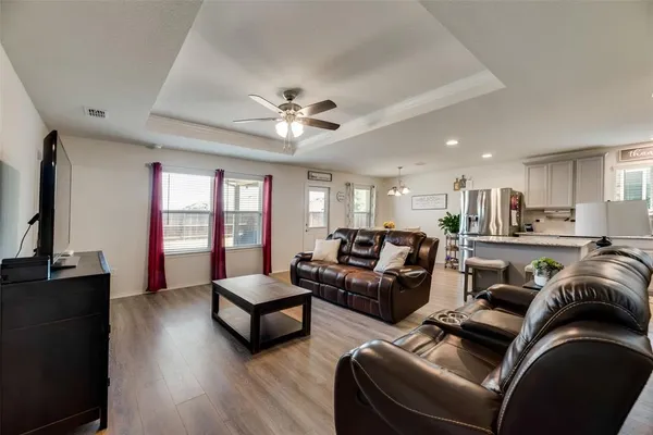 a living room with furniture ceiling fan and a rug