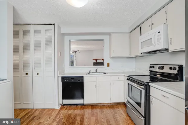 a kitchen with stainless steel appliances granite countertop a stove and a sink