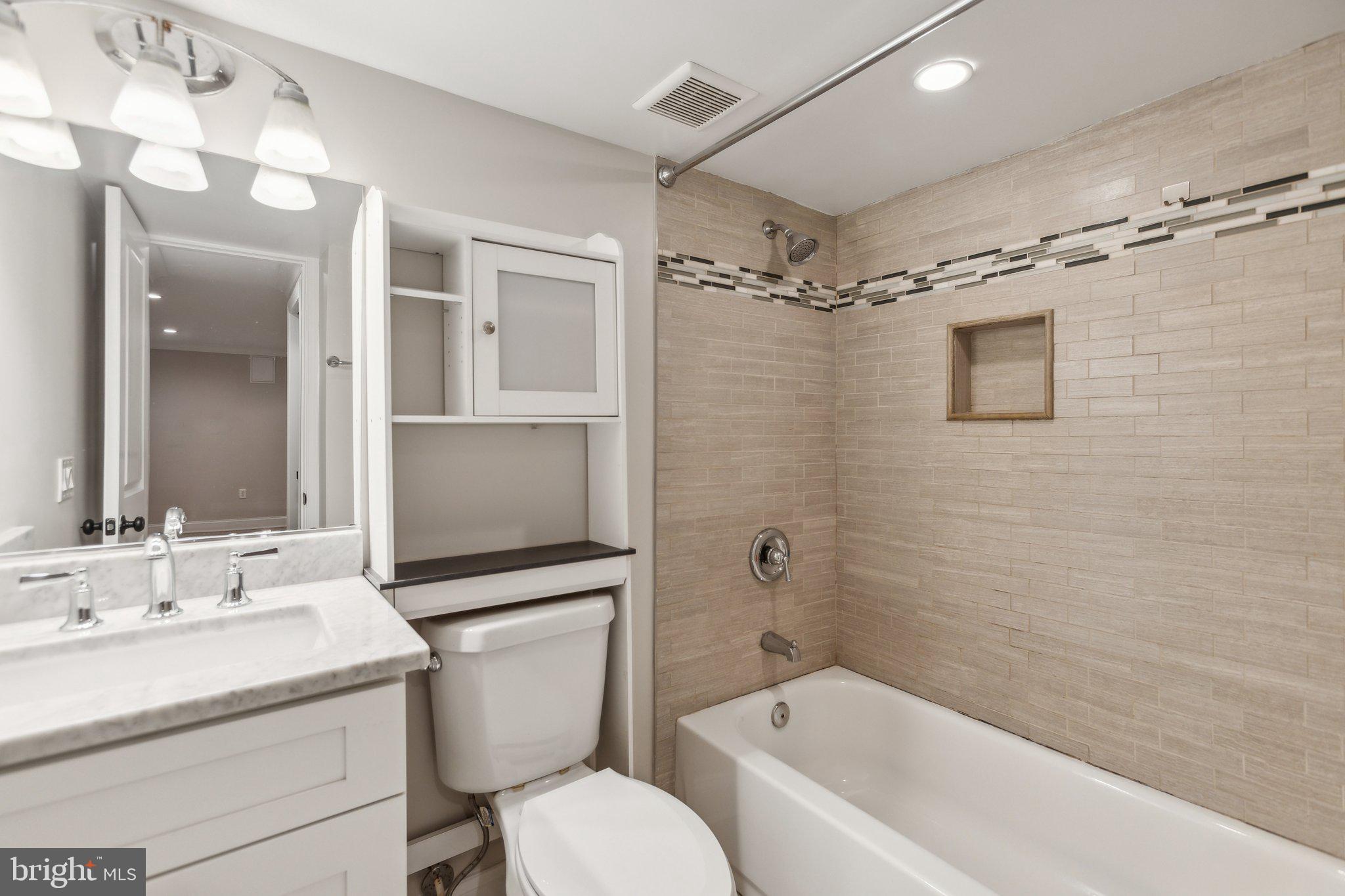 39 U Street Northeast, Unit 1 Washington, DC 20002 - Photo 16 of 22 a bathroom with a granite countertop sink toilet and shower