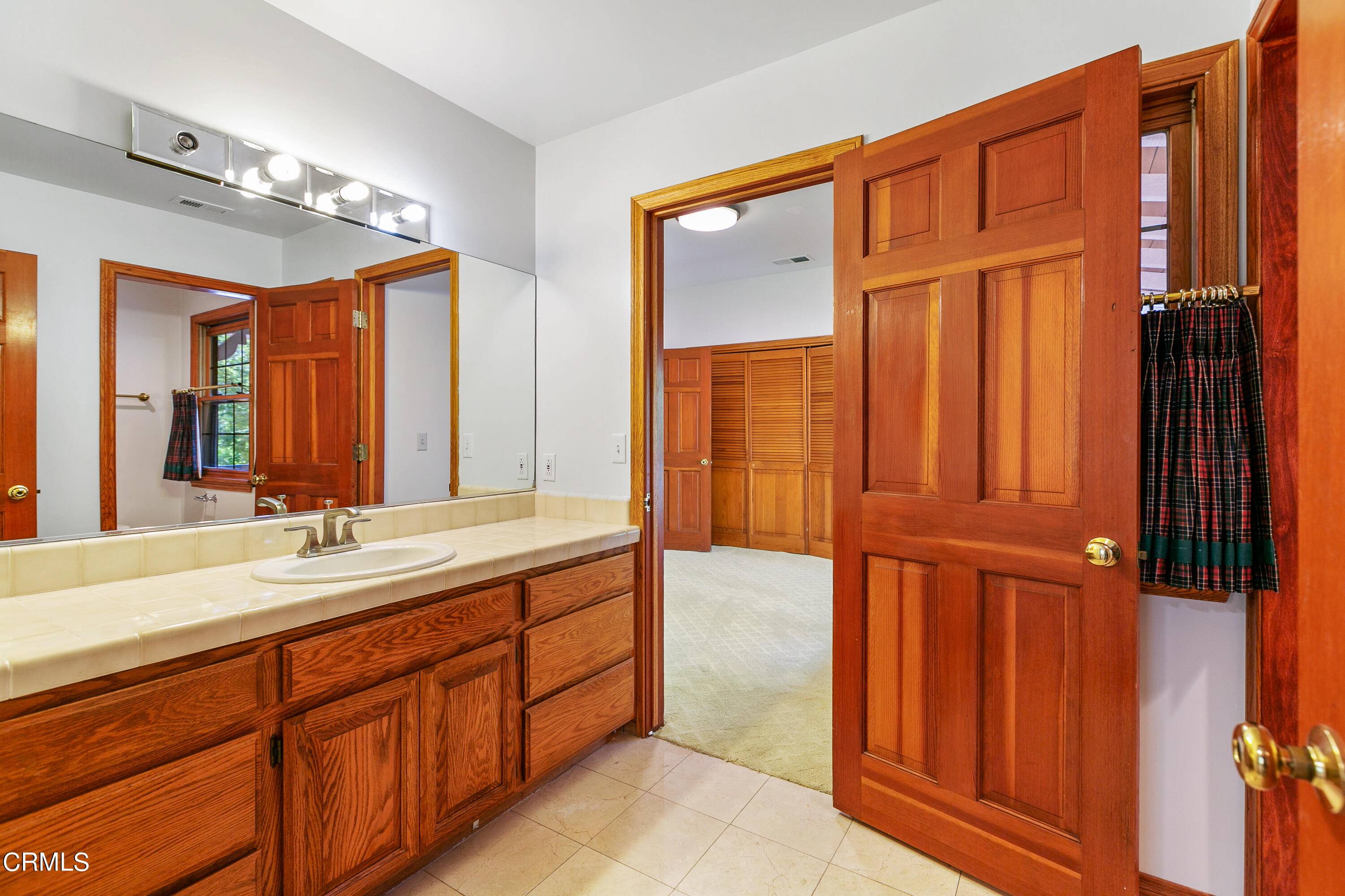 800 Greenridge Drive La Canada Flintridge, CA 91011 - Photo 46 of 58 a bathroom with a double vanity sink a mirror and a bathtub