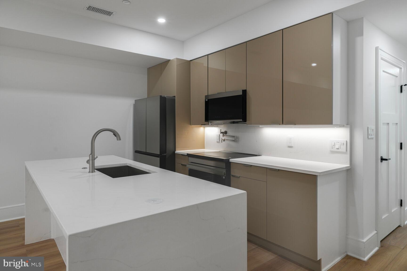 2524 41st Street Northwest, Unit 2 Washington, DC 20007 - Photo 11 of 25 a kitchen with a sink and a refrigerator