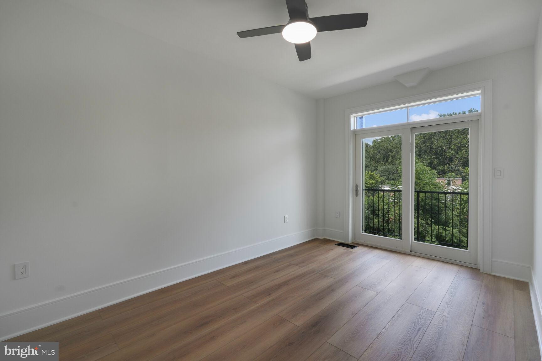 2524 41st Street Northwest, Unit 2 Washington, DC 20007 - Photo 13 of 25 a view of an empty room with wooden floor and a window