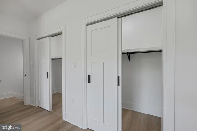 a view of closet area with wooden floor