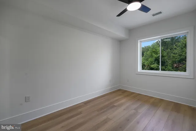 wooden floor in an empty room with a window