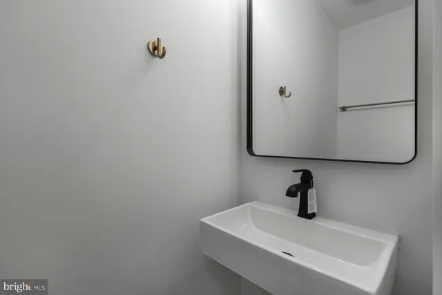a bathroom with a sink and mirror