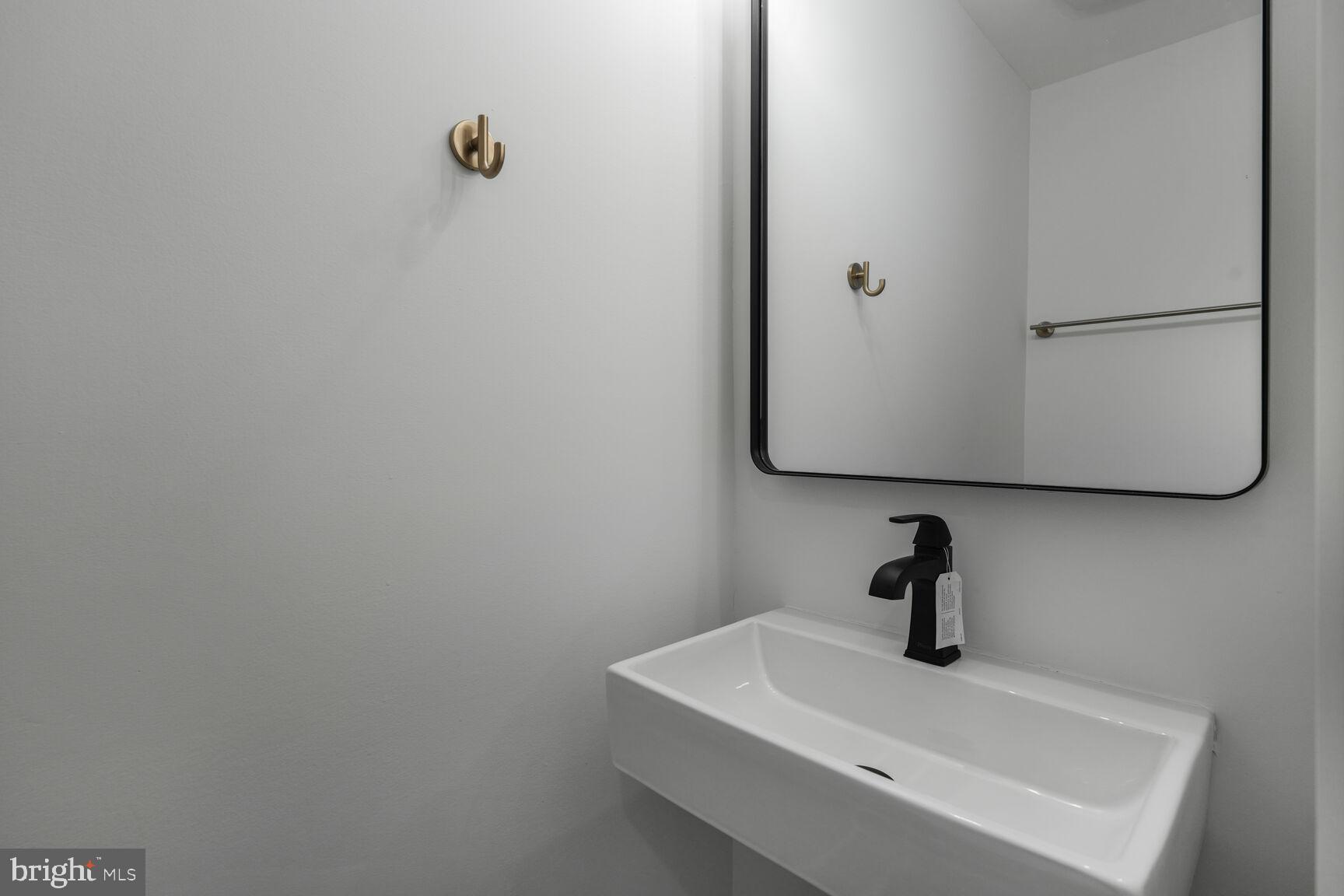 2524 41st Street Northwest, Unit 2 Washington, DC 20007 - Photo 18 of 25 a bathroom with a sink and mirror