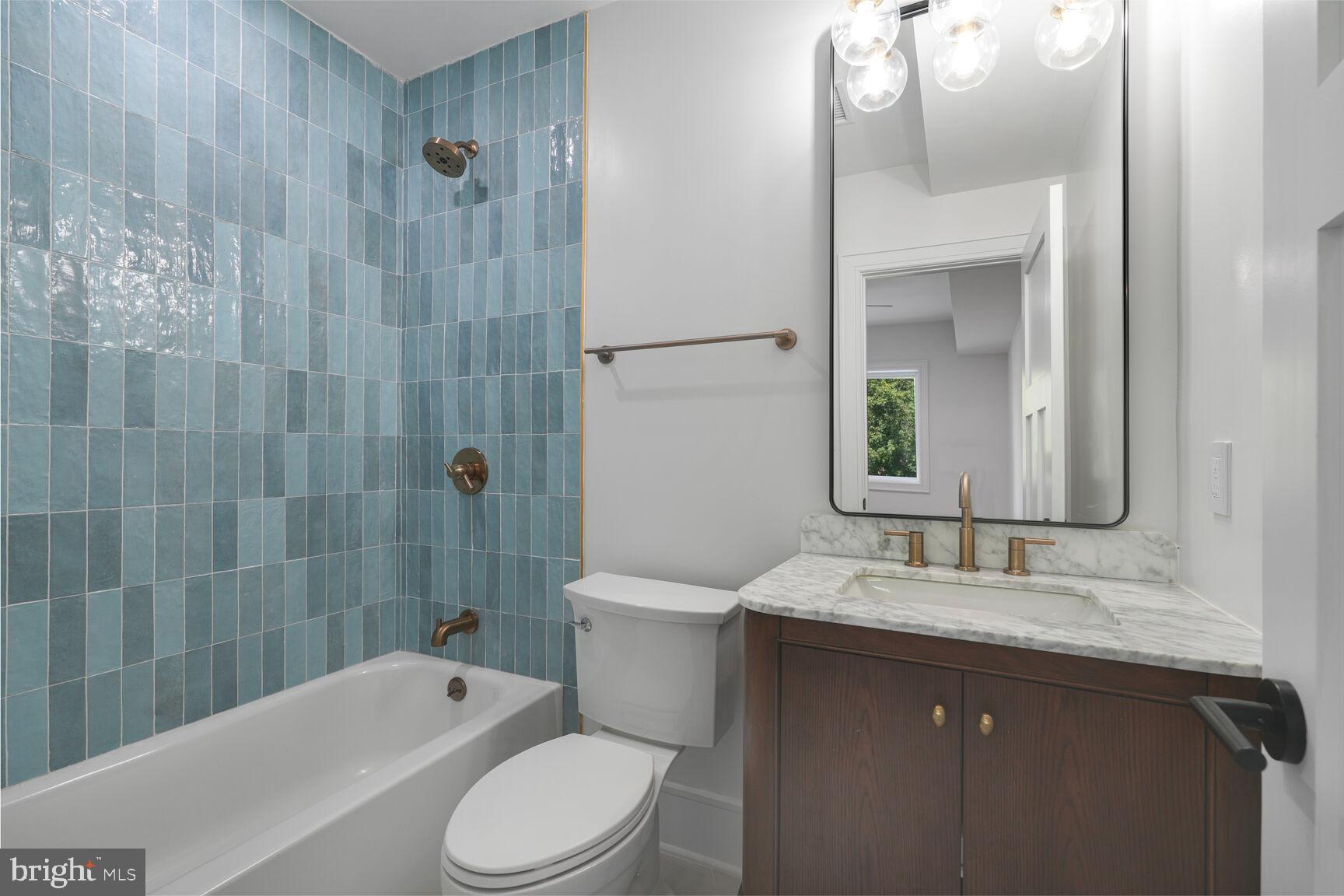 2524 41st Street Northwest, Unit 2 Washington, DC 20007 - Photo 19 of 25 a bathroom with a granite countertop sink toilet and shower