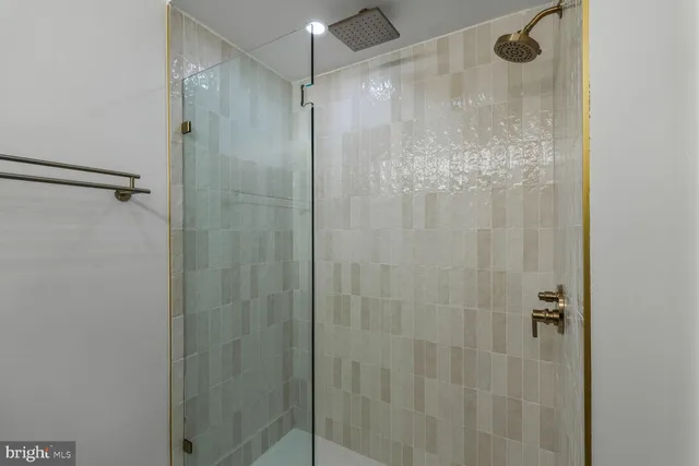a bathroom with a glass shower door