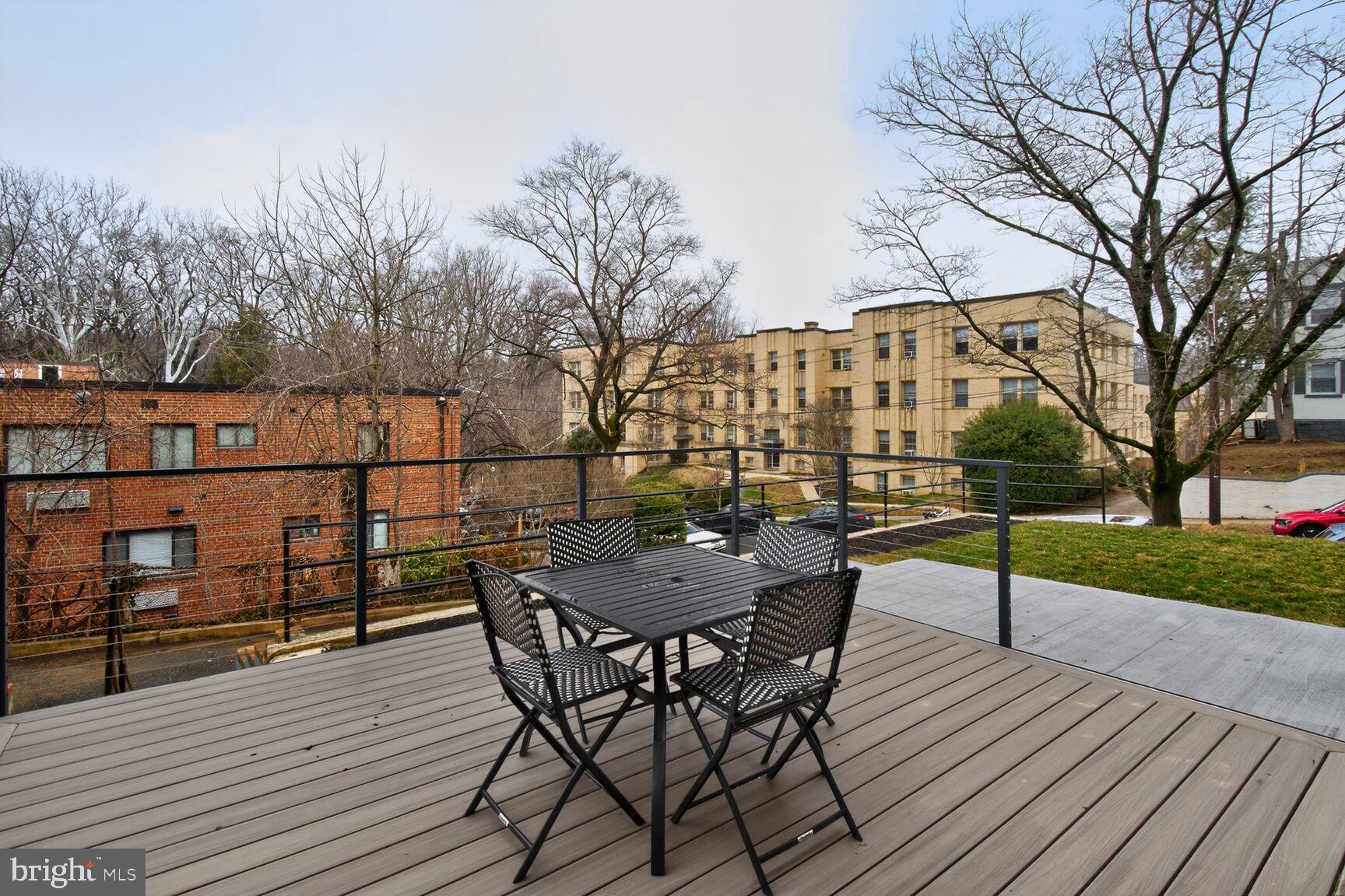 2524 41st Street Northwest, Unit 2 Washington, DC 20007 - Photo 25 of 27 a view of a roof deck with table and chairs a barbeque with wooden floor and fence