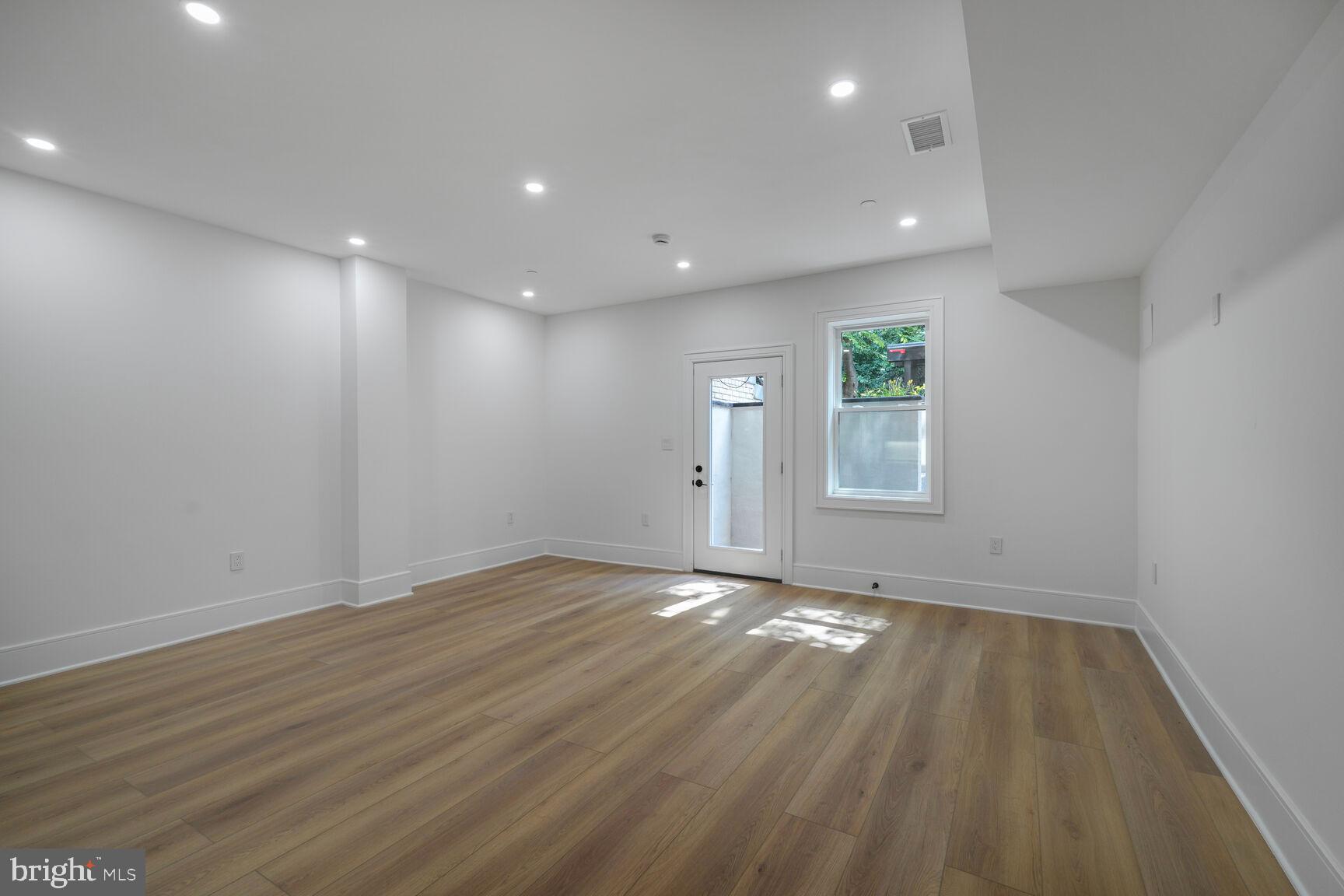 2524 41st Street Northwest, Unit 2 Washington, DC 20007 - Photo 6 of 25 a view of an empty room with wooden floor and a window