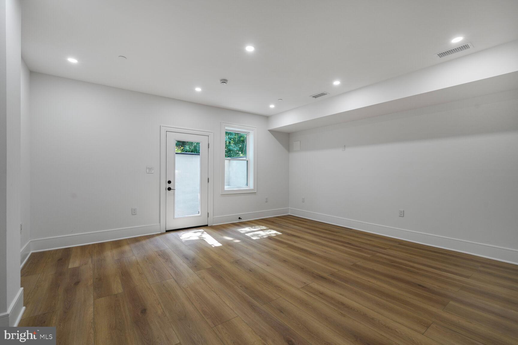 2524 41st Street Northwest, Unit 2 Washington, DC 20007 - Photo 7 of 25 an empty room with wooden floor and windows