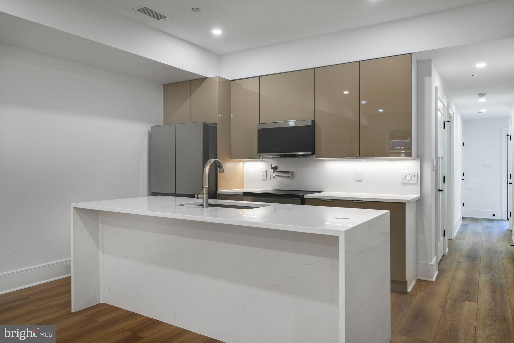 2524 41st Street Northwest, Unit 2 Washington, DC 20007 - Photo 8 of 25 a kitchen with appliances cabinets and a counter top space