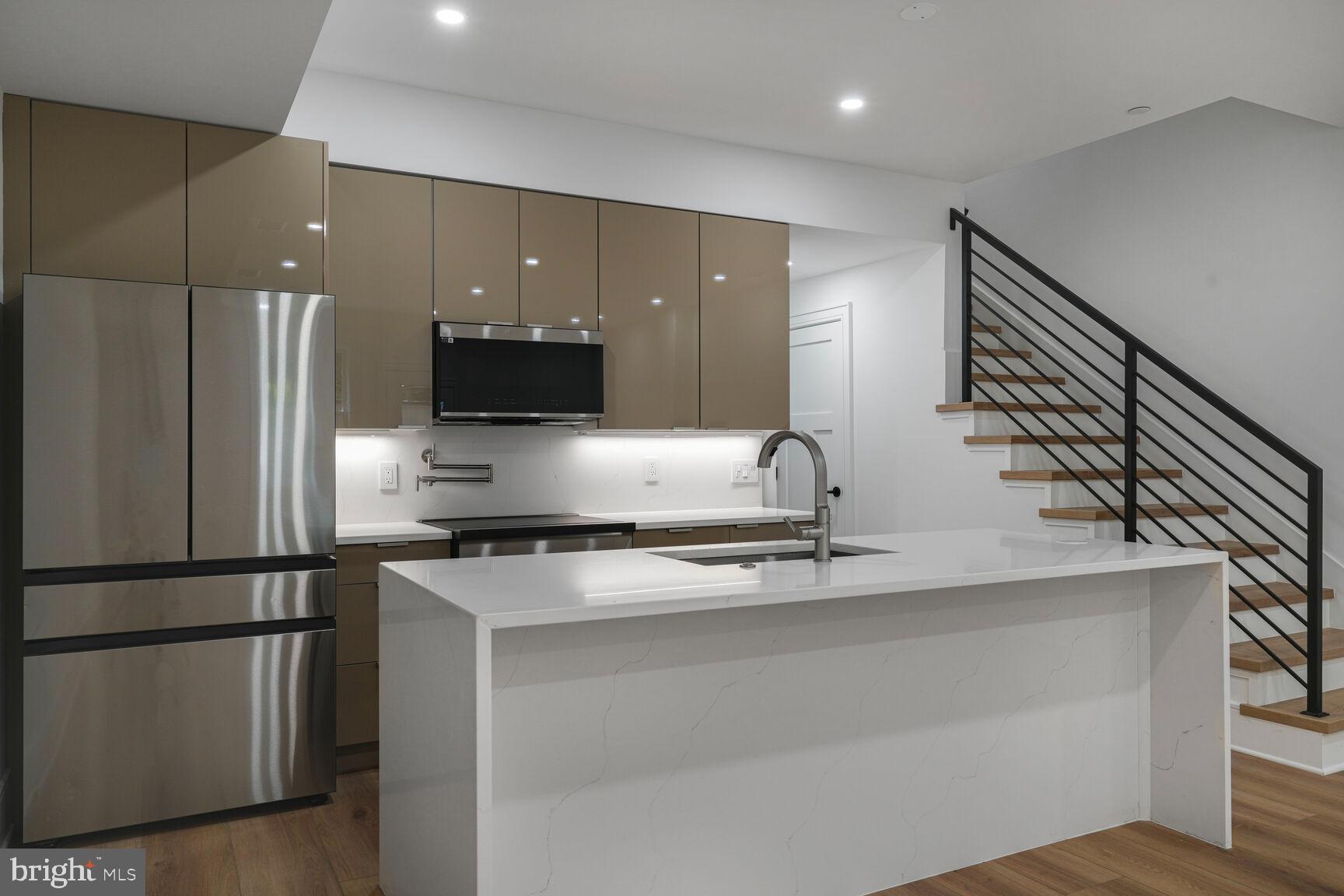 2524 41st Street Northwest, Unit 2 Washington, DC 20007 - Photo 9 of 25 a kitchen with stainless steel appliances granite countertop a refrigerator a sink and a stove