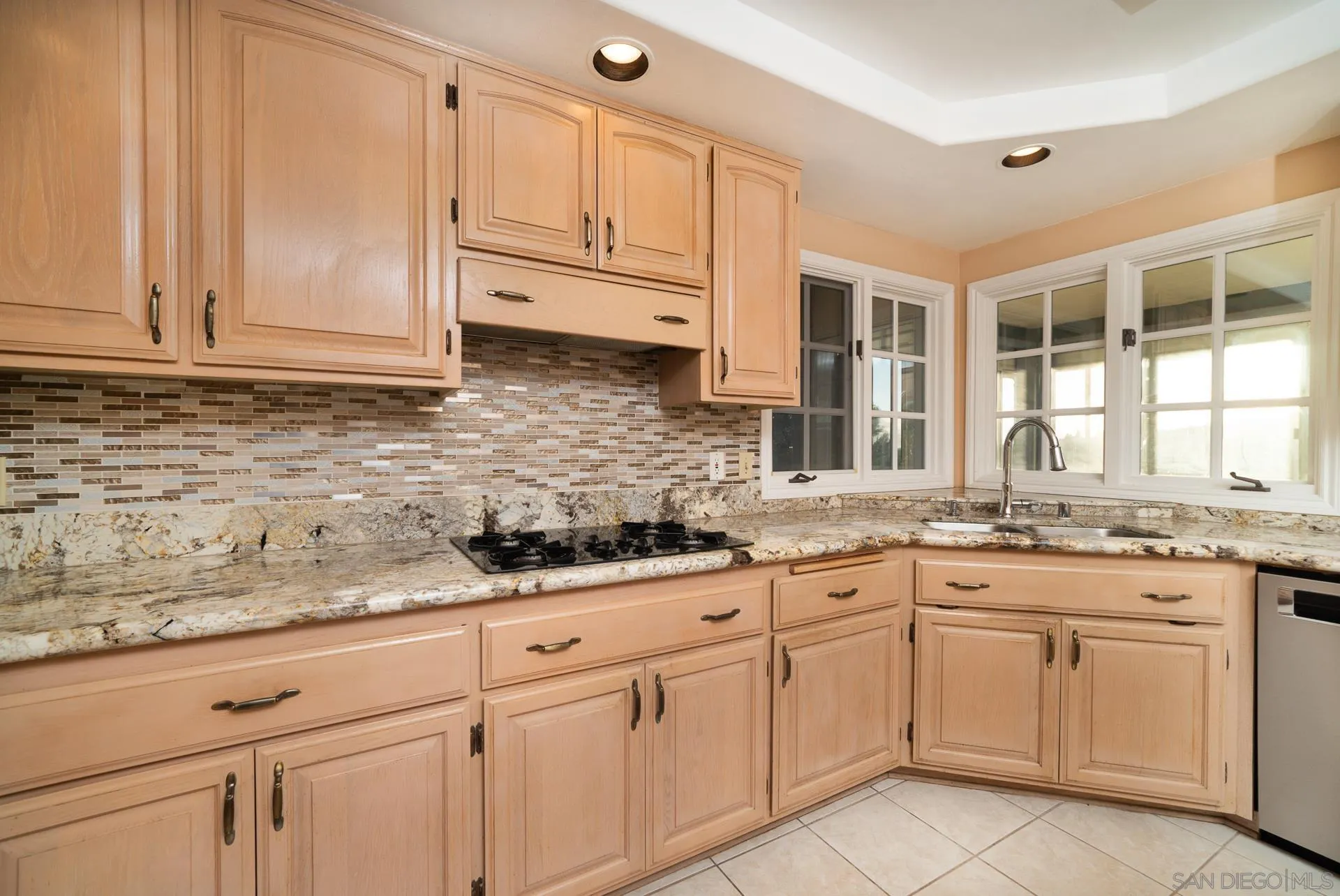 2908 Lakemont Drive Fallbrook, CA 92028 - Photo 11 of 70 a kitchen with granite countertop white cabinets and white stainless steel appliances